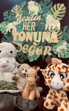 several stuffed animals sitting next to each other in front of a sign that says yeah, her honna keeper