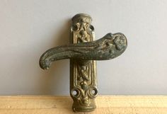 an old fashioned door handle on a wooden surface