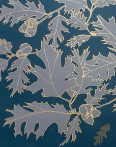 a close up view of some leaves on a table top with gold foiling over it