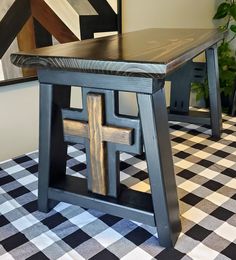 a wooden table sitting on top of a checkered floor