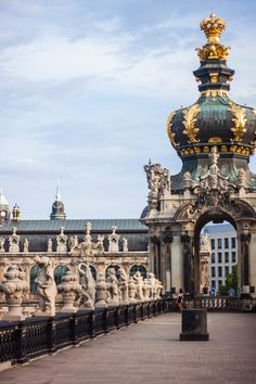 an ornate building with statues on the sides