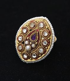 Gorgeous gemstone statement ring will wow at your next festive occasion 22k Yellow gold hypoallergenic, nickle and lead free Red enamel detail Pearl, Kundan and Amethyst gemstone Adjustable, one size fits most Unique Gold Enamel Ring With Gemstone, Gold Crystal Ring With Stones For Anniversary, Anniversary Gold Crystal Ring With Stones, Jeweled Wedding Ring, Gold Jeweled Open Ring Jewelry, Gold Ring With Stone Work, Gold Jeweled Rings For Gift, Jeweled Open Ring Jewelry Gift, Elegant Rings With Stone Work For Gift