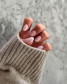 a woman's hand with pink and white nails