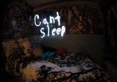 there is a neon sign that says can't sleep on the bed