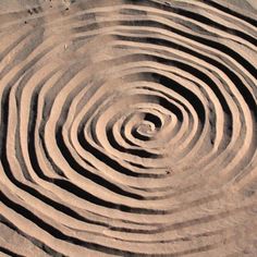 a circular design made out of sand on the beach