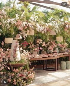 a table covered in lots of flowers and vases