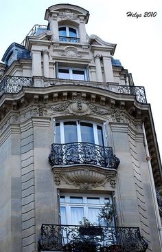 an ornate balcony and balconies on the side of a building in paris, france