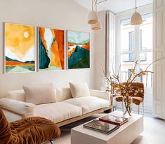 a living room with two paintings on the wall