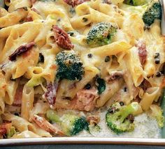 a casserole dish with chicken, broccoli and pasta in it on a table