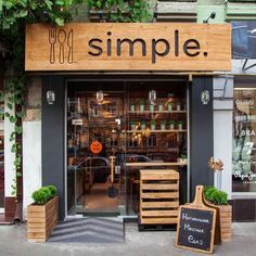 an image of a store front with plants growing out of the window and on the outside