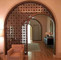 a living room filled with furniture and a wooden floor covered in intricately designed screens