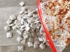 a red plastic bag filled with dog food next to a pile of puppy chow treats