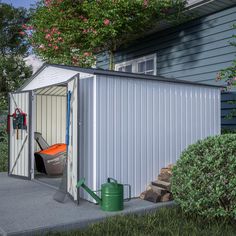 a small metal shed sitting on the side of a road next to a tree and bushes