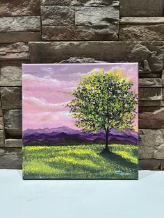 a painting of a tree on a stone wall