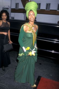 a woman in a green dress and headdress