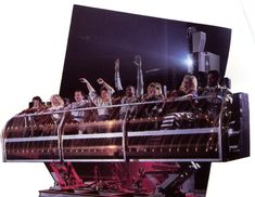 a group of people riding on top of a roller coaster