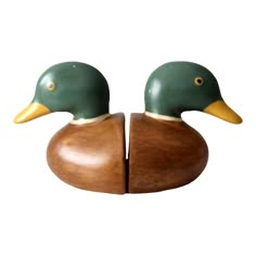 two wooden ducks sitting on top of each other