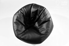 a black bean bag sitting on top of a white floor