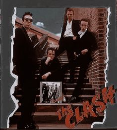 a group of men sitting on top of stairs in front of a brick wall with graffiti