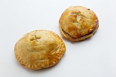 two small pastries sitting on top of a white countertop next to each other