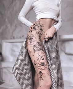 a woman with tattoos on her legs and leg