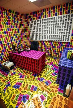 the room is decorated with many different colored blocks and shapes, including one large box