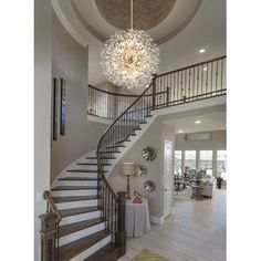 a large foyer with stairs and chandelier