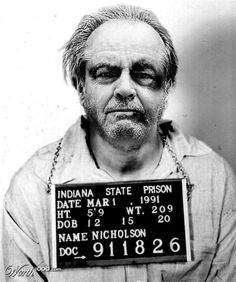 an old black and white photo of a man holding a sign that says indiana state prison