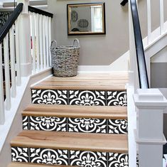 the stairs are decorated with black and white stencils for decorative wallpapers