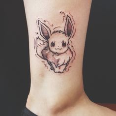 a small tattoo on the ankle of a woman's leg with a little bunny in it