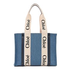 This is an authentic CHLOE Denim Shiny Calfskin Medium Woody Ribbon Tote in Navy. This chic tote is crafted of blue denim with blue leather trim. The bag features black Chlo logos vertically on the white fabric trim that extent into the top handles with navy leather accents. The top is open to a matching fabric interior with a patch pocket. Chloe Logo, Denim Tote, Leather Accents, Navy Leather, Chloe Bag, Fabric Trim, White Fabric, Blue Bags, White Fabrics