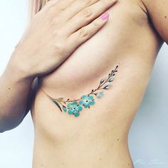 a woman's stomach with blue flowers on it