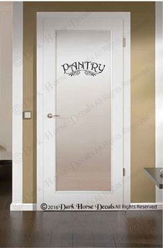 a white door with the word pantry on it in black lettering next to a wooden floor