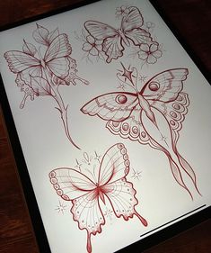 a drawing of three butterflies on a sheet of white paper with red ink in the middle