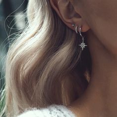 a close up of a person wearing earrings