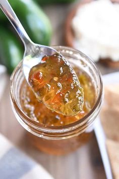 a spoon full of jam sitting on top of a table