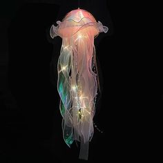 a light up jellyfish hanging in the dark