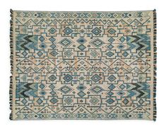 a blue and beige rug with an intricate design on the front, in different colors