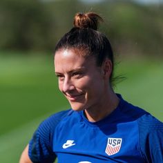 a female soccer player smiles at the camera