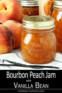 jars filled with peach jam sitting on top of a table