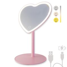 a heart shaped mirror on a pink stand with plugs and wires attached to it