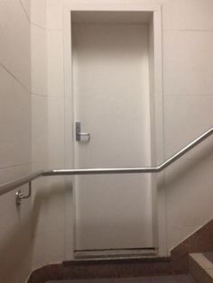 the door is open and there are steps leading up to the room with no one in it