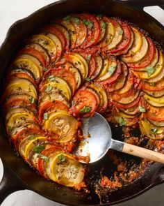 a skillet filled with sliced tomatoes and other vegetables