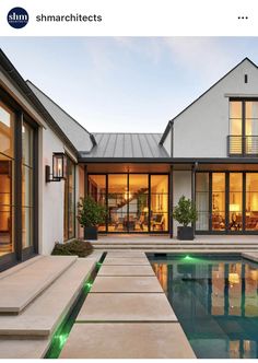 an outdoor swimming pool with steps leading up to it and the house in the background