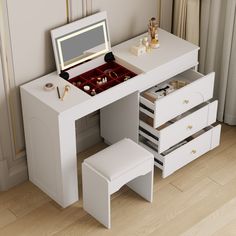 a white desk with drawers and a mirror on the top, along with two stools