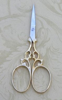 a pair of scissors sitting on top of a table