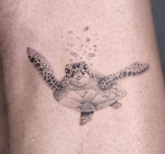 a tattoo of a sea turtle with bubbles coming out of it's back