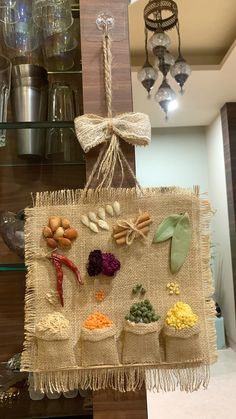 a burlap sign hanging from the side of a shelf filled with assorted items