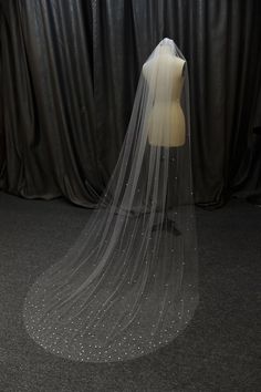 a wedding veil on top of a mannequin