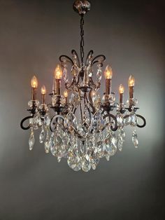 a chandelier with crystal drops hanging from it's center and four lights on each side